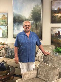 a man in blue shirt standing in a room